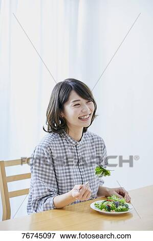 Young Japanese woman eating salad View Large Photo Image Stock Photo - Young Japanese woman eating salad. Fotosearch