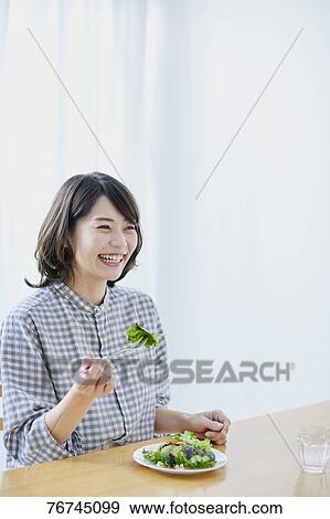 Young Japanese woman eating salad View Large Photo Image Stock Photo - Young Japanese woman eating salad. Fotosearch