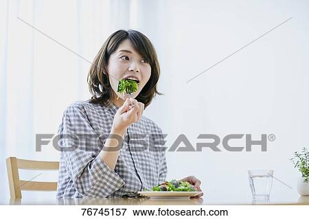 Young Japanese woman eating salad View Large Photo Image Stock Photo - Young Japanese woman eating salad. Fotosearch