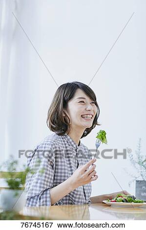 Young Japanese woman eating salad View Large Photo Image Stock Photo - Young Japanese woman eating salad. Fotosearch