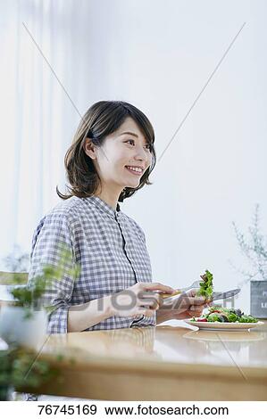 Young Japanese woman eating salad View Large Photo Image Stock Photo - Young Japanese woman eating salad. Fotosearch
