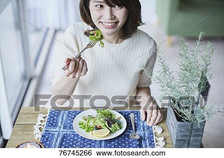 Young Japanese woman eating salad View Large Photo Image Stock Photograph - Young Japanese woman eating salad. Fotosearch
