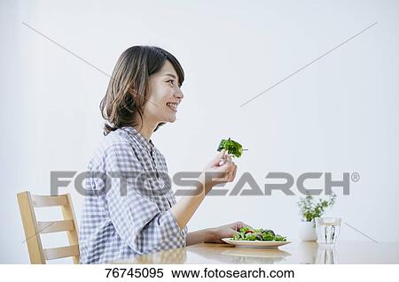 Young Japanese woman eating salad View Large Photo Image Stock Photography - Young Japanese woman eating salad. Fotosearch