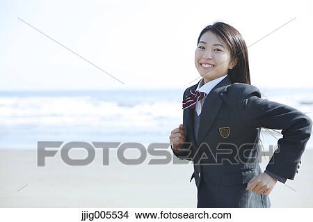 Young Japanese woman in a high school uniform running by the sea, Chiba, Japan View Large Photo Image Picture - Young Japanese woman in a high school uniform running by the sea, Chiba, Japan. Fotosearch