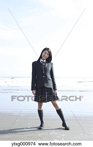 Young Japanese woman in a high school uniform by the sea, Chiba, Japan View Large Photo Image Picture - Young Japanese woman in a high school uniform by the sea, Chiba, Japan. Fotosearch
