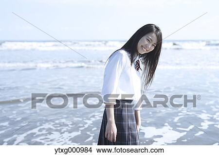 Young Japanese woman in a high school uniform by the sea, Chiba, Japan View Large Photo Image Picture - Young Japanese woman in a high school uniform by the sea, Chiba, Japan. Fotosearch