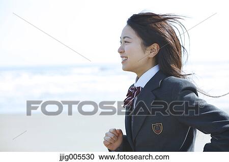 Young Japanese woman in a high school uniform running by the sea, Chiba, Japan View Large Photo Image Stock Image - Young Japanese woman in a high school uniform running by the sea, Chiba, Japan. Fotosearch
