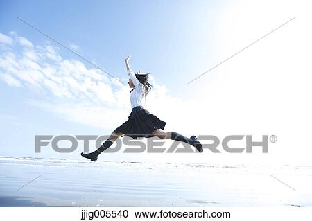 Young Japanese woman in a high school uniform jumping by the sea, Chiba, Japan View Large Photo Image Stock Image - Young Japanese woman in a high school uniform jumping by the sea, Chiba, Japan. Fotosearch