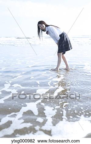 Young Japanese woman in a high school uniform by the sea, Chiba, Japan View Large Photo Image Stock Image - Young Japanese woman in a high school uniform by the sea, Chiba, Japan. Fotosearch