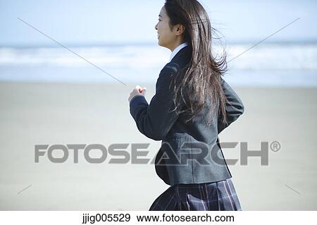 Young Japanese woman in a high school uniform running by the sea, Chiba, Japan View Large Photo Image Stock Photo - Young Japanese woman in a high school uniform running by the sea, Chiba, Japan. Fotosearch
