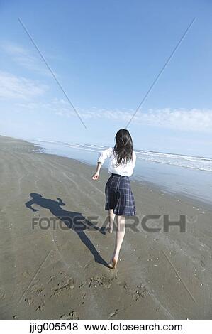 Young Japanese woman in a high school uniform running by the sea, Chiba, Japan View Large Photo Image Stock Photo - Young Japanese woman in a high school uniform running by the sea, Chiba, Japan. Fotosearch
