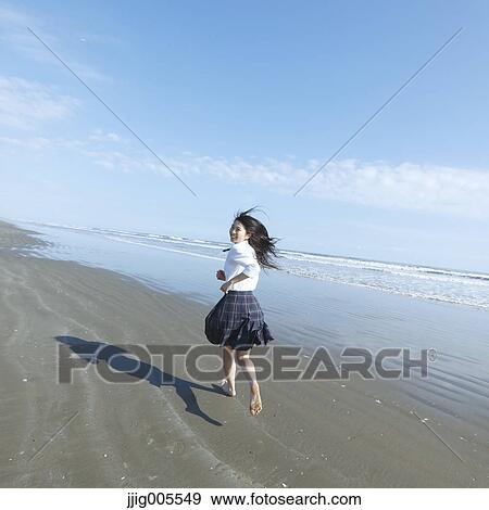 Young Japanese woman in a high school uniform running by the sea, Chiba, Japan View Large Photo Image Stock Photo - Young Japanese woman in a high school uniform running by the sea, Chiba, Japan. Fotosearch