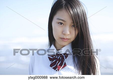 Young Japanese woman in a high school uniform by the sea, Chiba, Japan View Large Photo Image Stock Photo - Young Japanese woman in a high school uniform by the sea, Chiba, Japan. Fotosearch