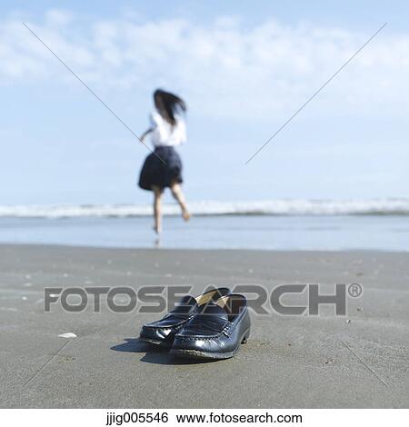 Young Japanese woman in a high school uniform running by the sea, Chiba, Japan View Large Photo Image Stock Photograph - Young Japanese woman in a high school uniform running by the sea, Chiba, Japan. Fotosearch