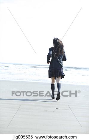 Young Japanese woman in a high school uniform running by the sea, Chiba, Japan View Large Photo Image Stock Photography - Young Japanese woman in a high school uniform running by the sea, Chiba, Japan. Fotosearch