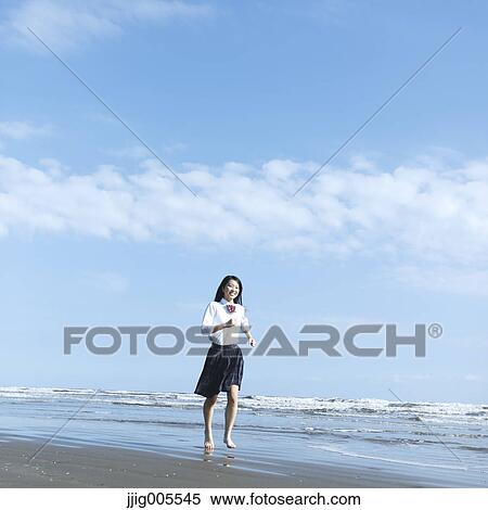 Young Japanese woman in a high school uniform running by the sea, Chiba, Japan View Large Photo Image Stock Photography - Young Japanese woman in a high school uniform running by the sea, Chiba, Japan. Fotosearch