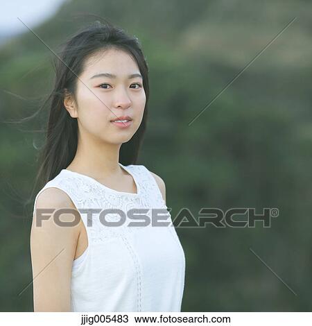 Young Japanese woman in a white dress at a cliff over the sea at sunrise, Chiba, Japan View Large Photo Image Stock Image - Young Japanese woman in a white dress at a cliff over the sea at sunrise, Chiba, Japan. Fotosearch