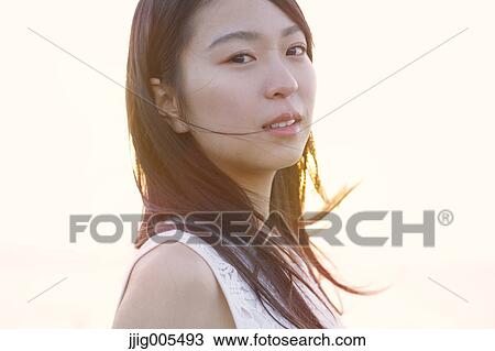 Young Japanese woman in a white dress at a cliff over the sea at sunrise, Chiba, Japan View Large Photo Image Stock Image - Young Japanese woman in a white dress at a cliff over the sea at sunrise, Chiba, Japan. Fotosearch