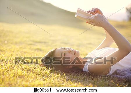 Young Japanese woman in a white dress at a cliff over the sea at sunrise, Chiba, Japan View Large Photo Image Stock Image - Young Japanese woman in a white dress at a cliff over the sea at sunrise, Chiba, Japan. Fotosearch