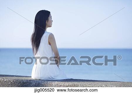 Young Japanese woman in a white dress by the sea, Chiba, Japan View Large Photo Image Stock Image - Young Japanese woman in a white dress by the sea, Chiba, Japan. Fotosearch