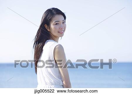 Young Japanese woman in a white dress by the sea, Chiba, Japan View Large Photo Image Stock Image - Young Japanese woman in a white dress by the sea, Chiba, Japan. Fotosearch