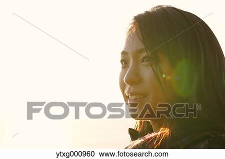 Young Japanese woman in a white dress at a cliff over the sea at sunrise, Chiba, Japan View Large Photo Image Stock Image - Young Japanese woman in a white dress at a cliff over the sea at sunrise, Chiba, Japan. Fotosearch