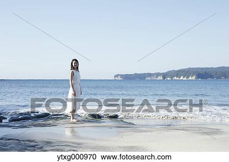 Young Japanese woman in a white dress by the sea, Chiba, Japan View Large Photo Image Stock Image - Young Japanese woman in a white dress by the sea, Chiba, Japan. Fotosearch