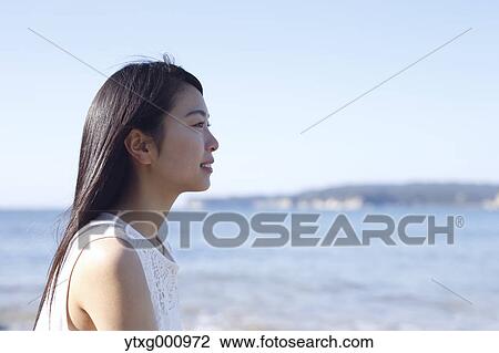 Young Japanese woman in a white dress by the sea, Chiba, Japan View Large Photo Image Stock Image - Young Japanese woman in a white dress by the sea, Chiba, Japan. Fotosearch