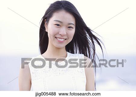 Young Japanese woman in a white dress at a cliff over the sea at sunrise, Chiba, Japan View Large Photo Image Stock Photo - Young Japanese woman in a white dress at a cliff over the sea at sunrise, Chiba, Japan. Fotosearch