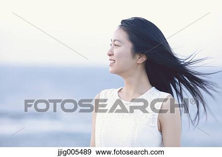 Young Japanese woman in a white dress at a cliff over the sea at sunrise, Chiba, Japan View Large Photo Image Stock Photo - Young Japanese woman in a white dress at a cliff over the sea at sunrise, Chiba, Japan. Fotosearch