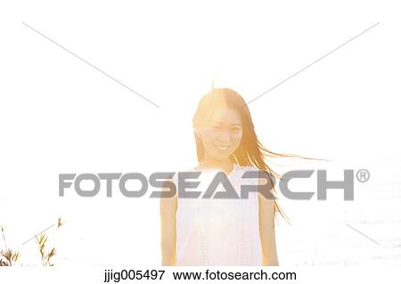 Young Japanese woman in a white dress at a cliff over the sea at sunrise, Chiba, Japan View Large Photo Image Stock Photo - Young Japanese woman in a white dress at a cliff over the sea at sunrise, Chiba, Japan. Fotosearch