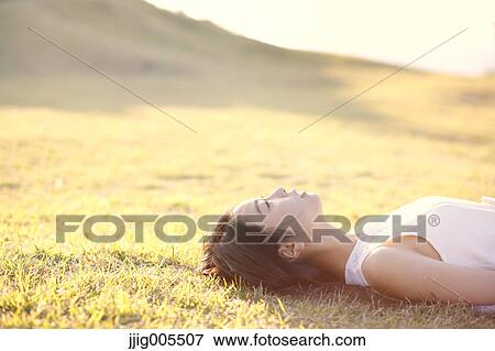 Young Japanese woman in a white dress at a cliff over the sea at sunrise, Chiba, Japan View Large Photo Image Stock Photo - Young Japanese woman in a white dress at a cliff over the sea at sunrise, Chiba, Japan. Fotosearch