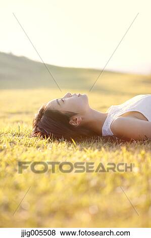 Young Japanese woman in a white dress at a cliff over the sea at sunrise, Chiba, Japan View Large Photo Image Stock Photo - Young Japanese woman in a white dress at a cliff over the sea at sunrise, Chiba, Japan. Fotosearch