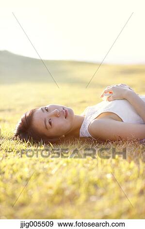 Young Japanese woman in a white dress at a cliff over the sea at sunrise, Chiba, Japan View Large Photo Image Stock Photo - Young Japanese woman in a white dress at a cliff over the sea at sunrise, Chiba, Japan. Fotosearch