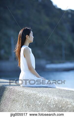 Young Japanese woman in a white dress by the sea, Chiba, Japan View Large Photo Image Stock Photo - Young Japanese woman in a white dress by the sea, Chiba, Japan. Fotosearch