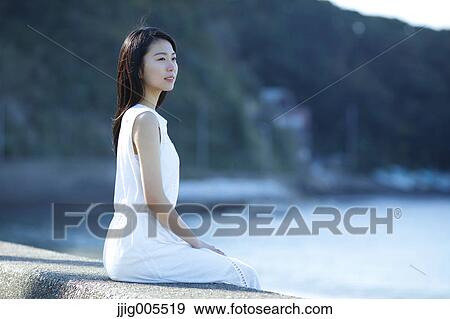 Young Japanese woman in a white dress by the sea, Chiba, Japan View Large Photo Image Stock Photo - Young Japanese woman in a white dress by the sea, Chiba, Japan. Fotosearch