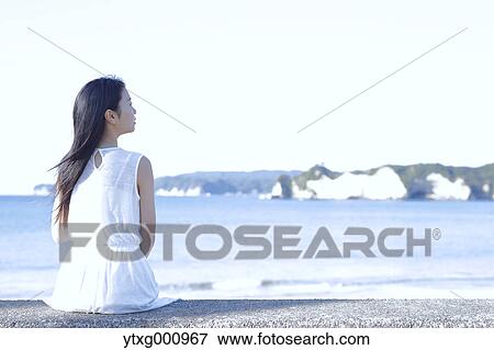 Young Japanese woman in a white dress by the sea, Chiba, Japan View Large Photo Image Stock Photo - Young Japanese woman in a white dress by the sea, Chiba, Japan. Fotosearch