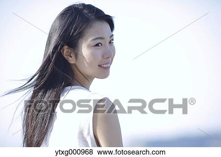 Young Japanese woman in a white dress by the sea, Chiba, Japan View Large Photo Image Stock Photo - Young Japanese woman in a white dress by the sea, Chiba, Japan. Fotosearch