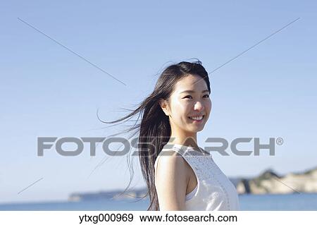 Young Japanese woman in a white dress by the sea, Chiba, Japan View Large Photo Image Stock Photo - Young Japanese woman in a white dress by the sea, Chiba, Japan. Fotosearch