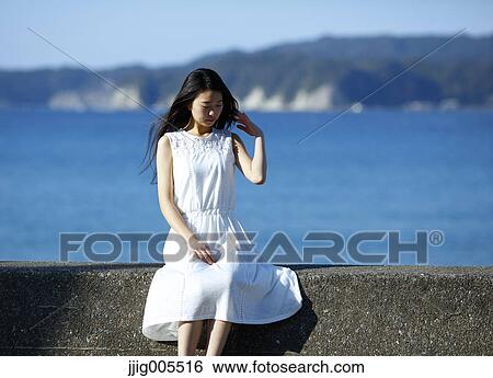 Young Japanese woman in a white dress by the sea, Chiba, Japan View Large Photo Image Stock Photograph - Young Japanese woman in a white dress by the sea, Chiba, Japan. Fotosearch