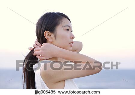 Young Japanese woman in a white dress at a cliff over the sea at sunrise, Chiba, Japan View Large Photo Image Stock Photography - Young Japanese woman in a white dress at a cliff over the sea at sunrise, Chiba, Japan. Fotosearch