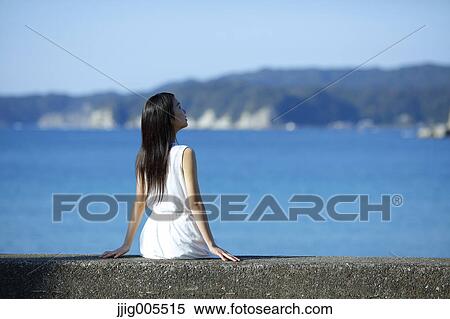 Young Japanese woman in a white dress by the sea, Chiba, Japan View Large Photo Image Stock Photography - Young Japanese woman in a white dress by the sea, Chiba, Japan. Fotosearch