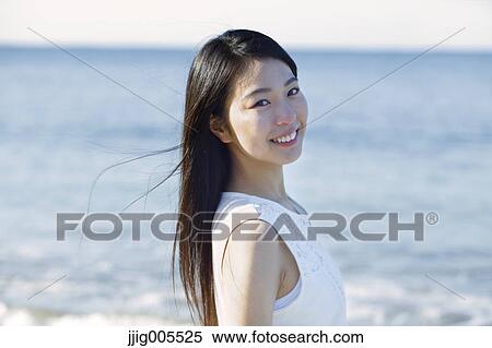 Young Japanese woman in a white dress by the sea, Chiba, Japan View Large Photo Image Stock Photography - Young Japanese woman in a white dress by the sea, Chiba, Japan. Fotosearch
