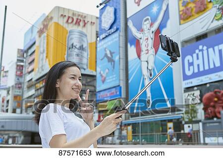 Stock Image - Young Japanese woman in Osaka. Fotosearch