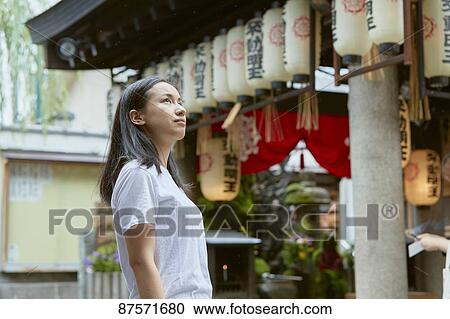 Stock Image - Young Japanese woman in Osaka. Fotosearch