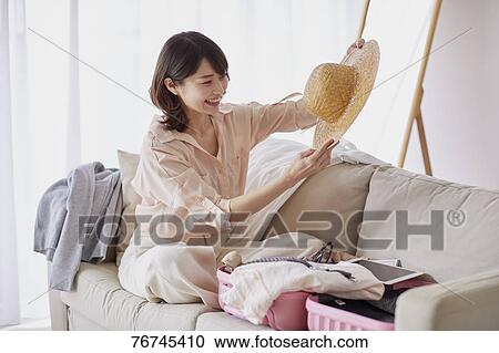 Young Japanese woman on sofa View Large Photo Image Stock Image - Young Japanese woman on sofa. Fotosearch
