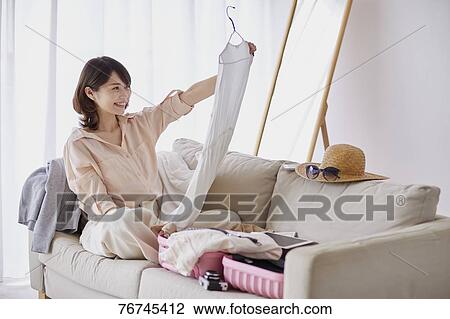 Young Japanese woman on sofa View Large Photo Image Stock Image - Young Japanese woman on sofa. Fotosearch