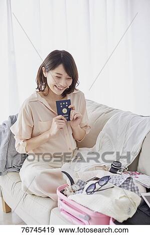 Stock Photo - Young Japanese woman on sofa. Fotosearch