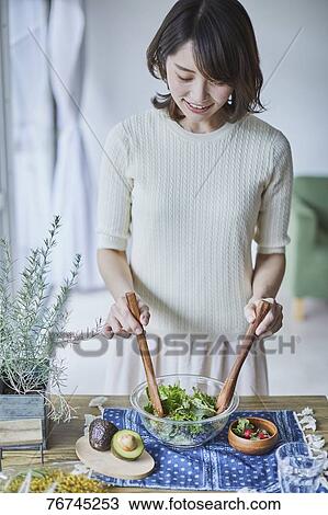 Young Japanese woman preparing salad View Large Photo Image Stock Image - Young Japanese woman preparing salad. Fotosearch