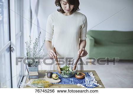 Young Japanese woman preparing salad View Large Photo Image Stock Photograph - Young Japanese woman preparing salad. Fotosearch